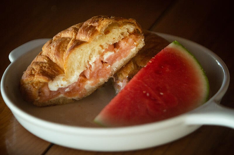 Salmon, cream cheese sandwich with slice of watermelon