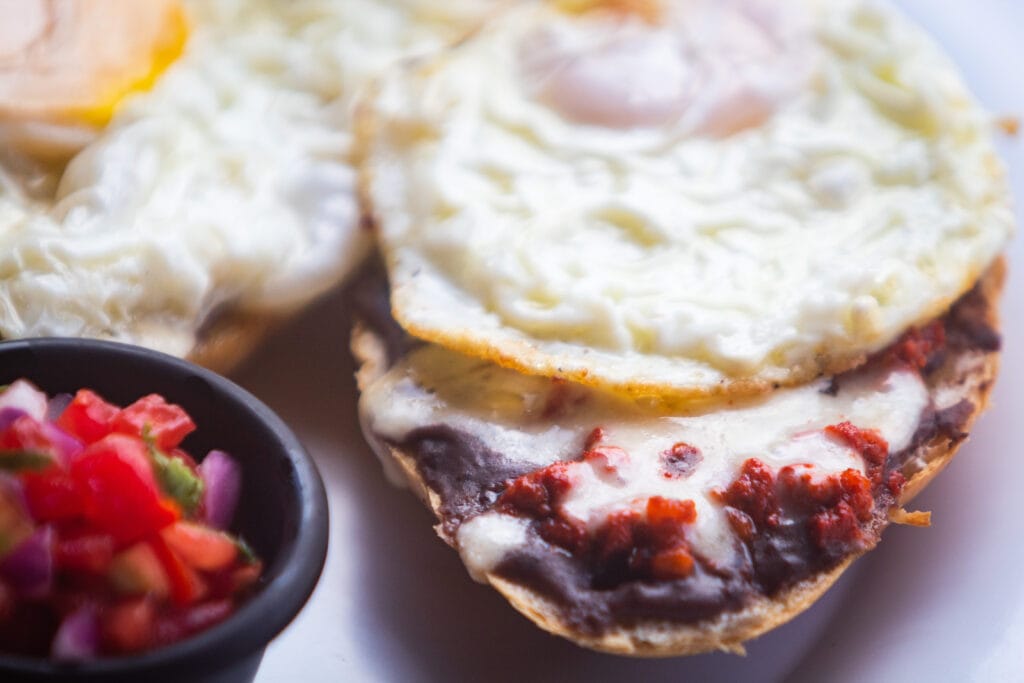 Close-up of molletes with sunnyside up eggs